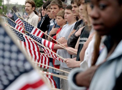 Local residents line the street as the funeral procession for Marine Lance Cpl. Walter O'Haire passes in Rockland, Massachusetts May 15, 2007. O'Haire was killed May 9 while on duty in Iraq.