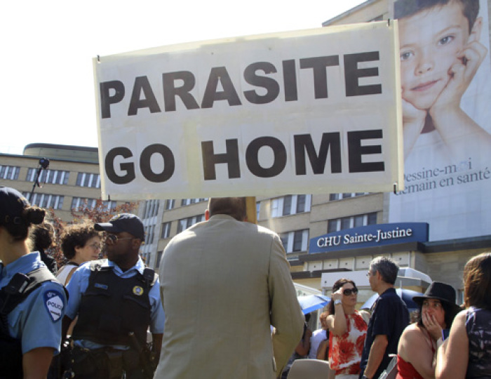 Protestors demonstrate in front of Sainte-Justine Hospital before the arrival of Britain's Prince William and his wife Catherine, Duchess of Cambridge, in Montreal July 2, 2011. Prince William and his wife Catherine, Duchess of Cambridge are on a royal tour from June 30 to July 8.