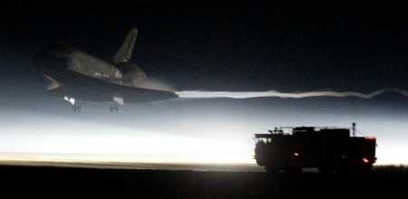 The space shuttle Atlantis makes a night landing at the Kennedy Space Center in Florida.