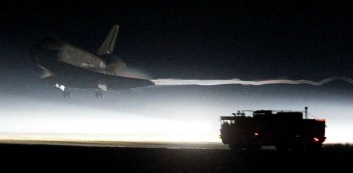 The space shuttle Atlantis makes a night landing at the Kennedy Space Center in Florida.