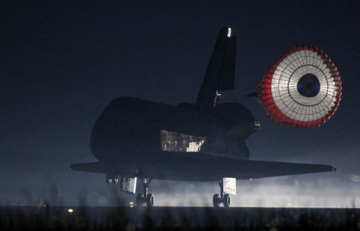 Space shuttle Atlantis STS-135 lands at the Kennedy Space Center in Cape Canaveral, Florida July 21, 2011.The space shuttle Atlantis glided home through a moonlit sky for its final landing at the Kennedy Space Center in Florida on Thursday, completing a 30-year odyssey for NASA's shuttle fleet.