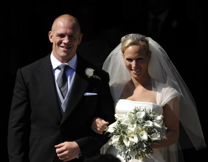 Britain's Zara Phillips, the eldest granddaughter of Queen Elizabeth, poses for a photograph with her husband England rugby captain Mike Tindall, after their marriage at Canongate Kirk in Edinburgh, Scotland, July 30, 2011.