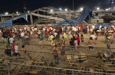 Concertgoers and emergency personnel hold up stage rigging after it collapsed minutes before a concert by Sugarland at the Indiana State Fairgrounds in Indianapolis August 13, 2011. Four people were killed and at least 40 people were hurt when the stage collapsed in windy weather at the fair on Saturday, just minutes before country music duo Sugarland was set to perform.