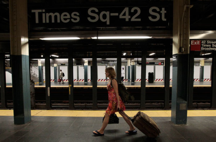 A woman walks through the Times Square subway station after the last subway has left, August 27, 2011. Mayor Michael Bloomberg sternly warned New Yorkers to follow the city's unprecedented mandatory evacuation orders on Saturday, saying approaching Hurricane Irene is 'life-threatening' and 'not a joke.' Some 370,000 of the city's more than 8 million residents are under orders to leave their homes in low-lying and waterfront areas, largely in the boroughs of Brooklyn and Queens and in the financial district in downtown Manhattan.