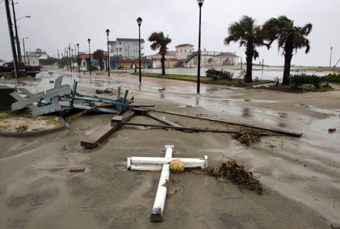 Debris and sand litters the road behind the town's main beach as the backside of Hurricane Irene comes ashore near Atlantic Beach, North Carolina, August 27, 2011.