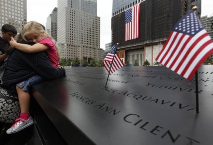 Family members of the 9/11 attacks on the World Trade Center visit the North Pool during ceremonies marking the 10th anniversary of the attacks in New York September 11, 2011.