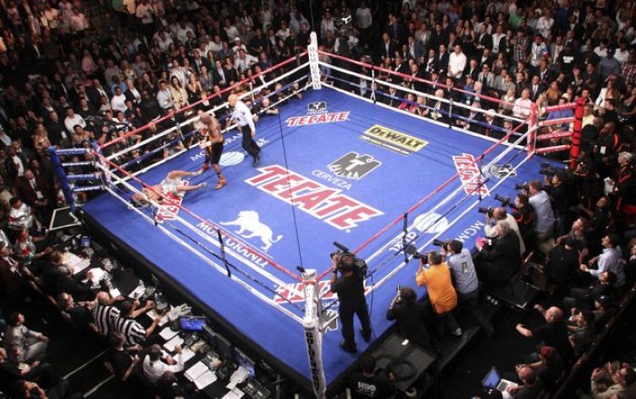 Floyd Mayweather Jr. (C) of the U.S. knocks out WBC welterweight champion Victor Ortiz, also of the U.S., during their title fight at the MGM Grand Garden Arena in Las Vegas, Nevada September 17, 2011. Mayweather Jr took the WBC welterweight title from Ortiz with a controversial fourth-round knockout on Saturday that prompted an angry response from the crowd and raised questions about his conduct in the ring.