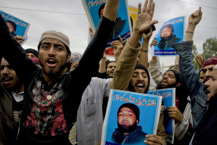 Supporters of various religious parties hold images of Malik Mumtaz Hussain Qadri and chant slogans in support of Qadri, the gunman detained for the killing of Punjab Governor Salman Taseer. The murder of the politician who opposed the country's anti-blasphemy laws, a case that exposed deep fissures in Pakistani society. The Urdu on the images read: 'We salute your courage.'