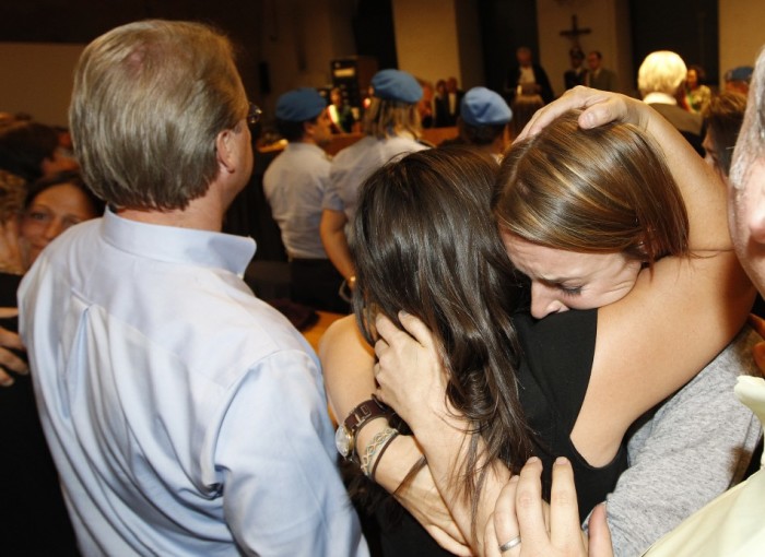 Amanda Knox's sister Deanna (R) and her mother Edda react as they hear the verdict during her appeal trial in Perugia October 3, 2011. An Italian court cleared 24-year-old American Amanda Knox and her former boyfriend of murdering British student Meredith Kercher in 2007 and ordered them to be set free on Monday after nearly four years in prison for a crime they always denied committing. Seattle native Knox and Italian computer student Raffaele Sollecito, had appealed against a 2009 verdict that found them guilty of murdering 21-year-old Kercher during what prosecutors said was a drug-fuelled sexual assault four years ago