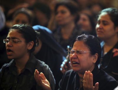 Egyptian Christian women grieve during a mass funeral for victims of sectarian clashes with soldiers and riot police at a protest against an attack on a church in southern Egypt at Abassaiya Cathedral in Cairo October 10, 2011. Thousands of mourners attend a funeral ceremony for those killed in overnight clashes when troops crushed a protest over an attack on a church in the worst violence since the uprising that toppled Hosni Mubarak.