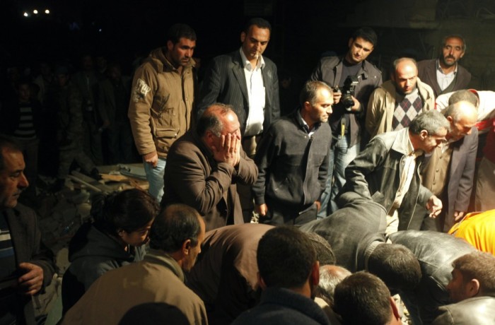 A man weeps as rescue workers try to save his son, trapped under debris from the earthquake that rocked eastern Turkey, on Oct. 23, 2011.