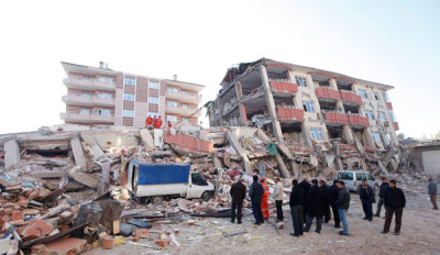 Rescue workers work to save people trapped under debris after an earthquake in Ercis, near the eastern Turkish city of Van, early October 24, 2011. More than 200 people were killed and hundreds more feared dead on Monday after an earthquake struck parts of southeast Turkey, where rescue teams worked through the night to try to free survivors crying for help from under rubble.