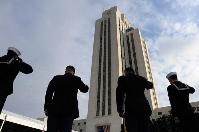 U.S. service members stand and salute during the playing of the national anthem at the dedication ceremony for the Walter Reed National Military Medical Center in Bethesda, Maryland, November 10, 2011.