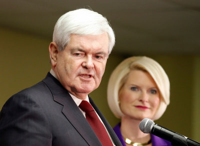 Republican presidential candidate and former U.S. House Speaker Newt Gingrich speaks to supporters with his wife Callista beside him during a Newt 2012 campaign office opening in Urbandale, Iowa December 10, 2011.