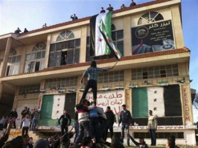 Demonstrators against Syria's President Bashar al-Assad gather in Homs on December 13, 2011.