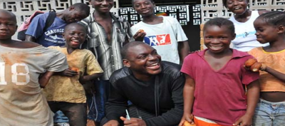 African warlord turned Christian evangelist Joshua Blahyi pictured with children he's ministered to.