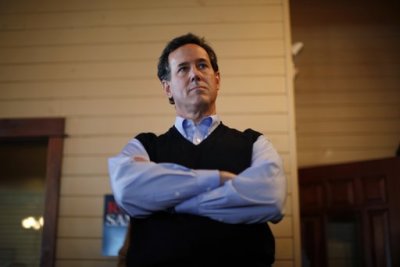 Republican presidential candidate Rick Santorum waits to be introduced to supporters at a campaign stop at the Button factory restaurant in Muscatine, Iowa December 29, 2011.