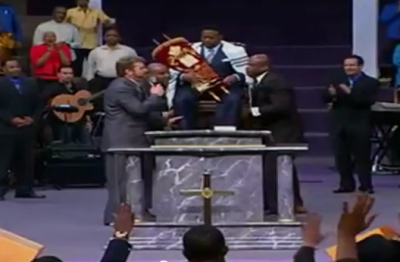 Bishop Eddie Long is seen 'crowned' as 'King' during a televised service at New Birth Missionary Baptist Church involving Rabbi Ralph Messer on Jan. 29, 2012.