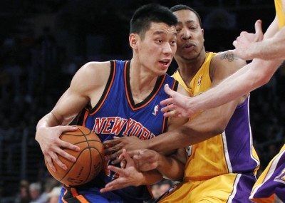 Newly acquired New York Knicks guard Jeremy Lin (L) is fouled by Los Angeles Lakers' Andrew Goudelock (R) during second half of an NBA basketball game in Los Angeles, in this Dec. 29, 2011 file photo.