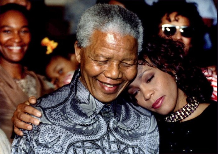 South African President Nelson Mandela and American pop star Whitney Houston smile for photographers in Johannesburg in this Nov. 10, 1994 file photo.