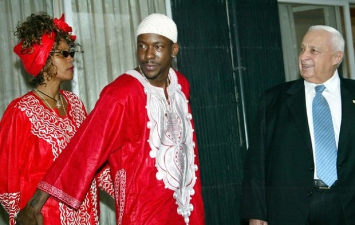 Former Israeli Prime Minister Ariel Sharon (R) meets with U.S. singer Whitney Houston and her former husband Bobby Brown in Jerusalem, in this file photo taken May 27, 2003.