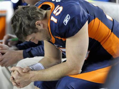 Tim Tebow says a prayer on the sidelines before beginning a game. (File)