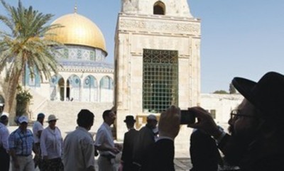 An ultra-Orthodox Jewish man takes a picture in front of the Dome of the Rock on the compound known to Muslims as al-Haram al-Sharif, and to Jews as Temple Mount, in Jerusalem's Old City Sept. 18, 2011.