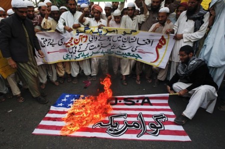 Supporters of the Jamiat Talba-e-Arabia group chant slogans while burning a U.S. flag during an anti-American rally in Karachi Feb. 22, 2012, after the burning of copies of the Quran at NATO's main base in Afghanistan.