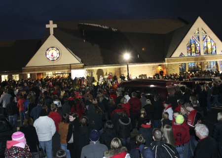 People gather outside St. Mary's of Chardon for a candlelight vigil remembering the victims of a school shooting in Chardon, Ohio February 28, 2012. Three students were killed and two others wounded by suspect TJ Lane in Monday's shooting rampage at the Ohio high school.