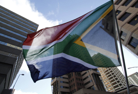 A South African waves a flag in Cape Town in this file photo.