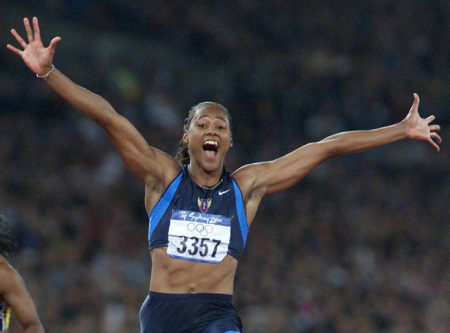 Marion Jones of the U.S. celebrates her win in the women's 100m final at the Sydney Olympic Games, in this September 23, 2000 file photo. Jones admitted using steroids as she prepared for the 2000 Olympics.