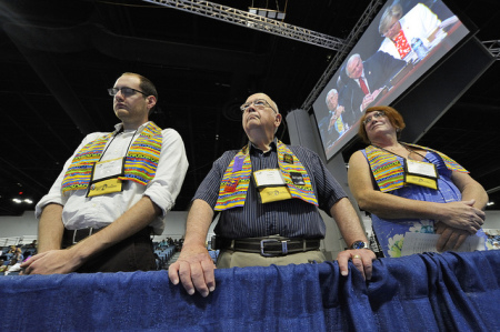 Dozens of demonstrators demanding a more inclusive church hold vigil at the edge of the May 3 session of the 2012 United Methodist General Conference in Tampa, Florida.