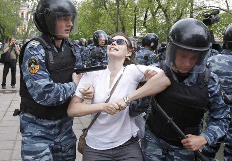 Riot police detain an opposition supporter during an unsanctioned protest in Moscow May 7, 2012.