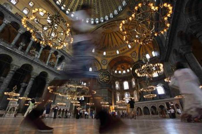 Local and foreign tourists visit the Byzantine monument of Hagia Sophia, or Ayasofya, which is now a museum in Istanbul June 7, 2012.