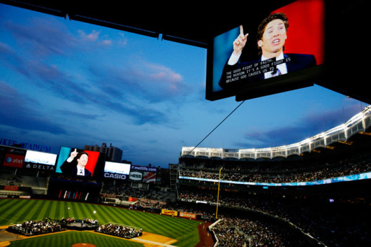 Evangelist Joel Osteen is seen on a video monitor during the 'Historic Night of Hope' at Yankee Stadium in New York April 25, 2009.