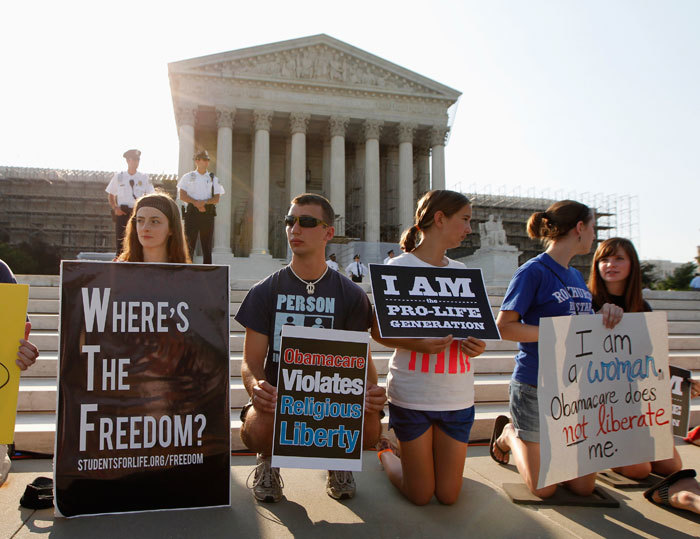 Protesters against U.S. President Barack Obama's health care overhaul gather outside the Supreme Court in Washington, June 28, 2012. The Supreme Court is set to deliver on Thursday its ruling on President Barack Obama's 2010 healthcare overhaul, his signature domestic policy achievement, in a historic case that could hand him a huge triumph or a stinging rebuke just over four months before he seeks re-election.