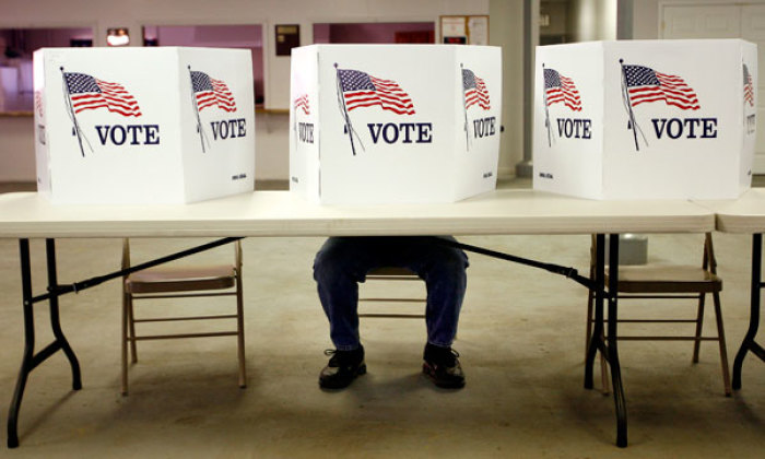 A voter casts a ballot at the Flushing Volunteer Fire Department in Flushing, Ohio, March 6, 2012.