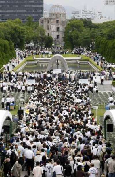 People gather to pray in front of a cenotaph for the victims of the 1945 atomic bombing of Japan, in the Peace Memorial Park in Hiroshima August 6, 2009, the 64th anniversary of America's atomic bombing of the city.