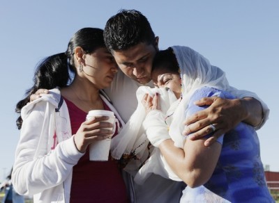 Mourners, including Amardeep Kaleka (C) whose father, temple president Satwant Kaleka, was killed, cry outside the scene of a mass shooting in Oak Creek, Wis., Aug. 6, 2012.