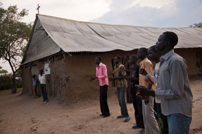 Men sing outside the Presbyterian Church in Pibor before a church service, in South Sudan, June 24, 2012. For decades, Sudan's southerners fought the country's predominately Arab rulers in the north. More than two million people died before the fighting ended in a peace deal in 2005. In a referendum promised by the pact, 99 percent of the southerners chose to secede, and on July 9, 2011, the flag of South Sudan was raised over Juba, the rickety new capital.