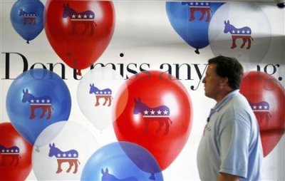 A man walks past an advertisement for the Democratic National Convention at the Charlotte Douglas International Airport in Charlotte, North Carolina September 2, 2012.