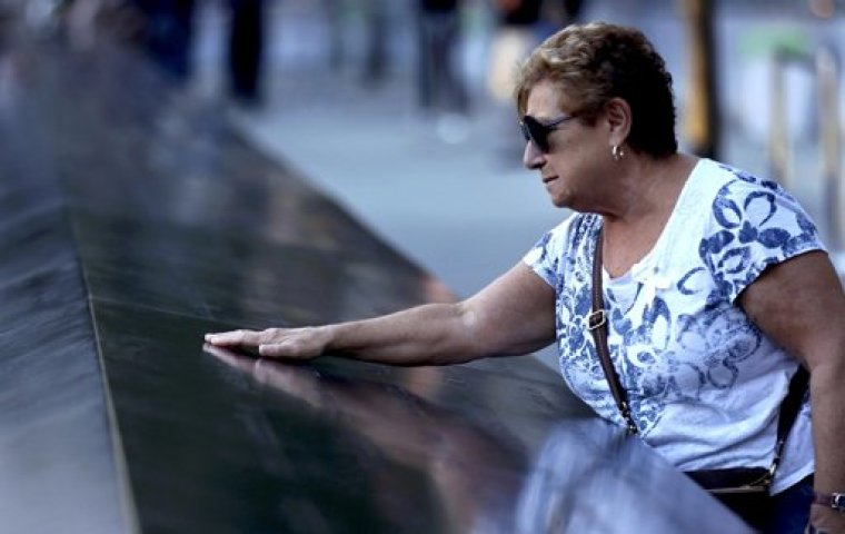 Amelia Tedesco of Staten Island, New York, touches the inscribed name of her son-in-law Walter Baran, also of Staten Island, during ceremonies marking the 11th anniversary of the 9/11 attacks on the World Trade Center in New York, September 11, 2012. Baran was killed on the 90th floor of the south tower during the attacks.