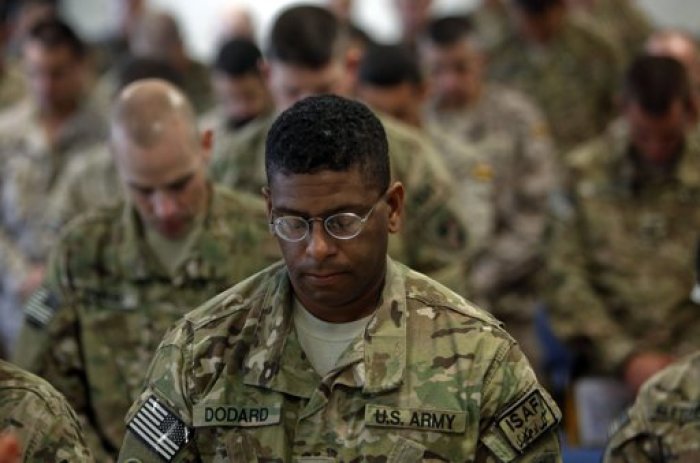 U.S. troops pray during a ceremony marking the 11th anniversary of the 9/11 attacks in the United States, in Kabul September 11, 2012.