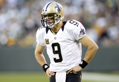 New Orleans Saints quarterback Drew Brees pauses during a time out against the Green Bay Packers in the second half during their NFL football game in Green Bay, Wisconsin September 30, 2012.