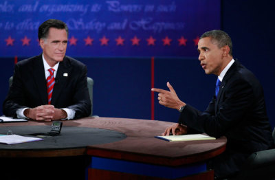 U.S. President Barack Obama (R) speaks as Republican presidential nominee Mitt Romney (L) listens during the final U.S. presidential debate in Boca Raton, Florida October 22, 2012.