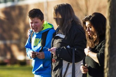 A boy weeps as he is told what happened after being picked up at Reed Intermediate School following a shooting at Sandy Hook Elementary School in Newtown, Connecticut, December 14, 2012.