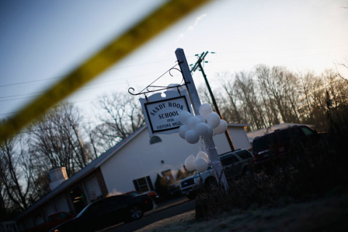 Balloons hang from the Sandy Hook Elementary School sign in Sandy Hook in Newtown, Connecticut December 15, 2012. People in the small Connecticut community of Newtown grieved on Saturday over one of the worst mass shootings in U.S. history and police sought answers about what drove a 20-year-old gunman to slaughter 20 children at an elementary school.