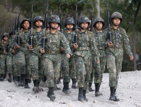 Newly recruited female marines march with fellow soldiers during drills inside the marine headquarters in the town of Ternate, Cavite city, south of Manila February 5, 2013.