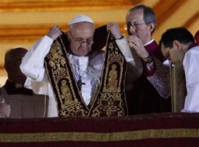 Newly elected Pope Francis (L), Cardinal Jorge Mario Bergoglio of Argentina appears on the balcony of St. Peter's Basilica after being elected by the conclave of cardinals, at the Vatican, March 13,.