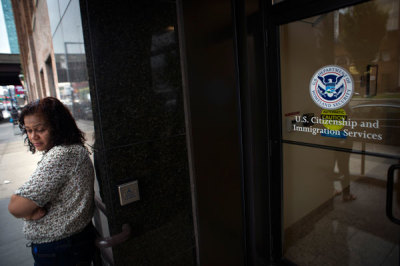 A woman stands on the steps of the U.S. Citizenship and Immigration Services offices in New York, August 15, 2012. The U.S. government began accepting applications on Wednesday from young illegal immigrants seeking temporary legal status under relaxed deportation rules announced by the Obama administration in June.